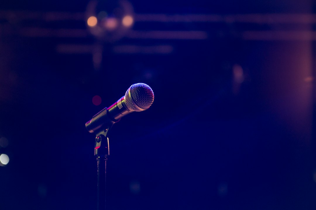 Concert stage and microphone illustrating Sayuri Kokusho's music career