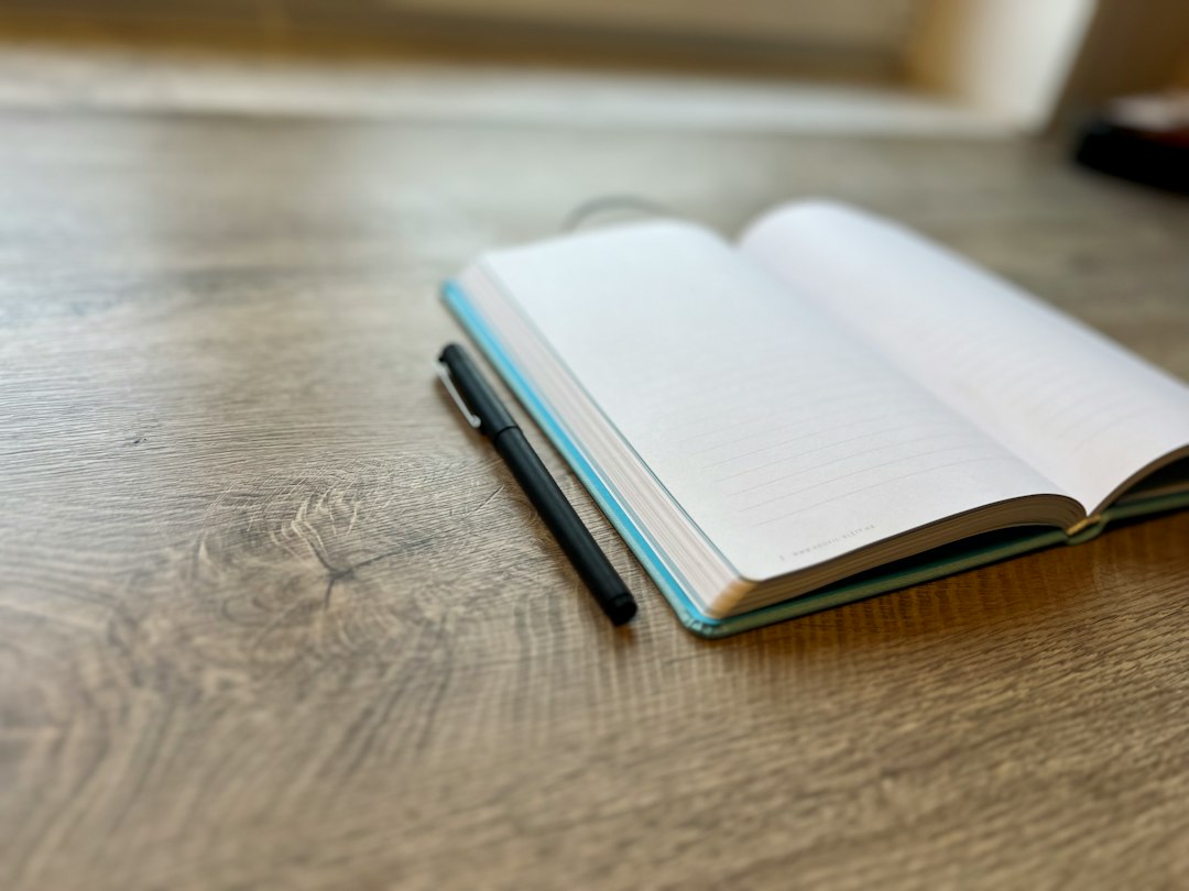 Pen and book illustrating Martin Olson's writing career; not a portrait